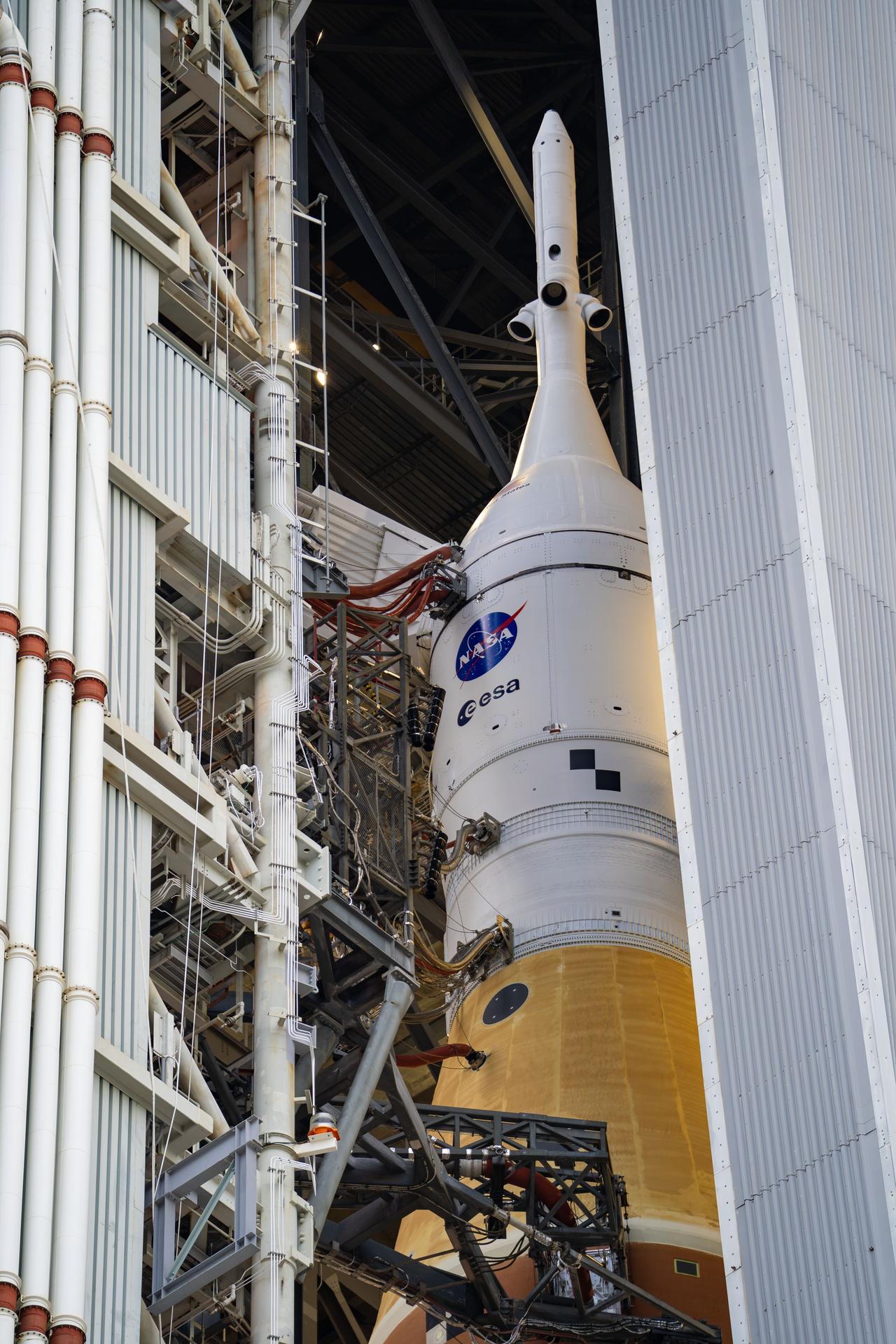 This image shows NASA’s SLS (Space Launch System) and Orion spacecraft rolling out of the Vehicle Assembly Building at NASA’s Kennedy Space Center. NASA's massive Crawler-Transporter, upgraded for the Artemis program, carries the powerful SLS rocket and Orion spacecraft on the Mobile Launcher from the Vehicle Assembly Building to Launch Pad 39B at Kennedy Space Center in preparation for the Artemis II mission.
